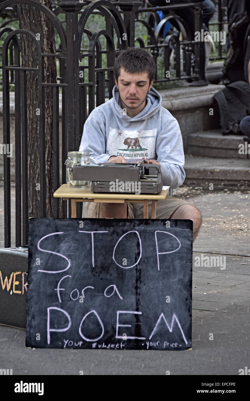 An poet and street busker soliciting money for writing poems in Union Square Park, New York City Stock Photo