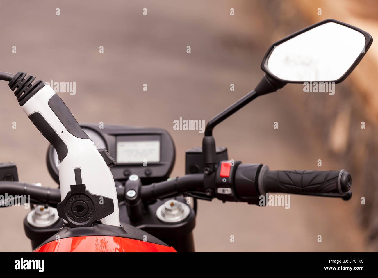 Electric motorcycle plugged in for recharging, Stock Photo