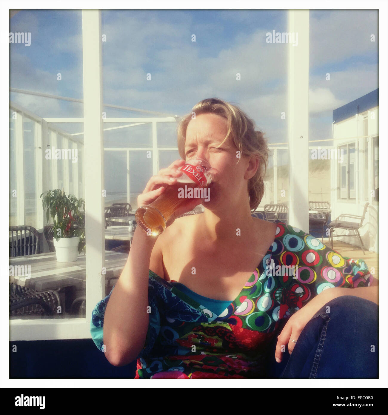 Dutch woman drinking a local brewed texels beer Stock Photo