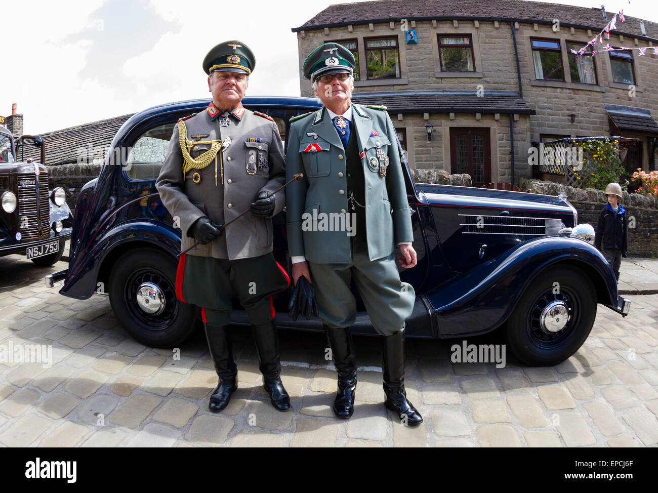 Haworth, West Yorkshire, UK. 16th May, 2015. Two men dressed in German Army uniforms at Haworth 1940s weekend, an annual event in which people dress in period costume and visit the village of Haworth to relive the 1940s. After complaints in previous years, the organisers have requested that people don't wear German Uniforms. Credit:  West Yorkshire Images/Alamy Live News Stock Photo