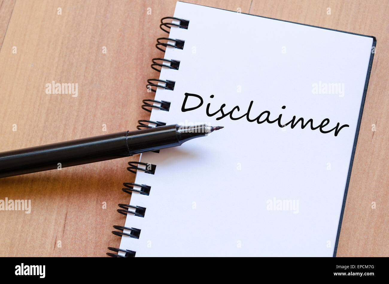 White notepad and ink pen on the wooden desk Disclaimer Concept Notepad Stock Photo