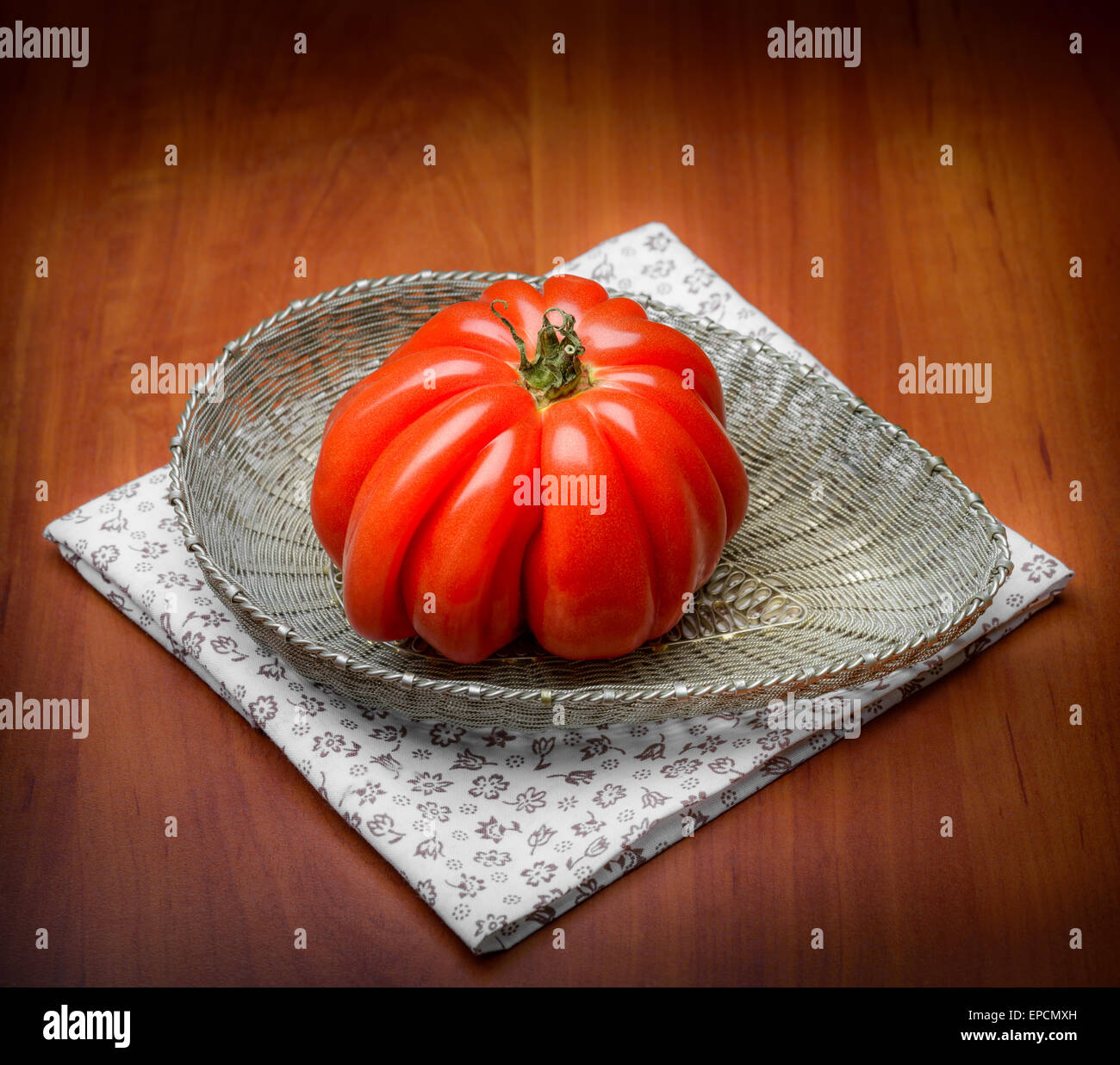 Nice Beef Heart tomato, Olena Ukraina, shown in a silver filigree basket, like a gem from nature Stock Photo