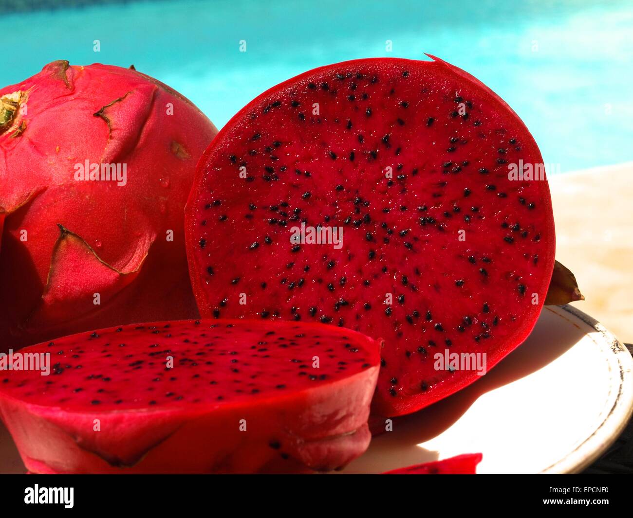 Whole Pitaya next to a Pitaya cut in half Stock Photo