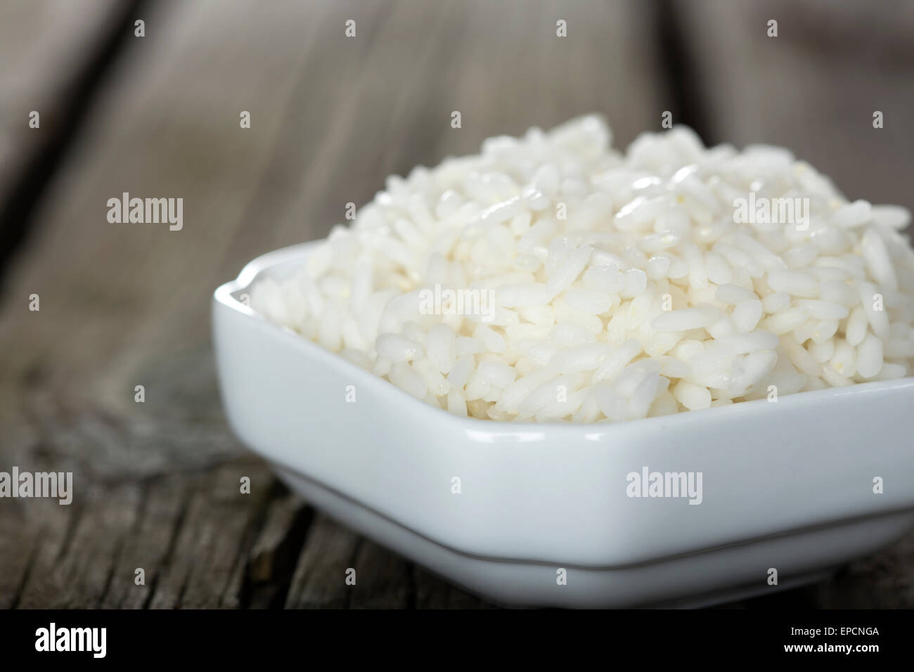 Bowl full of rice over wooden background Stock Photo