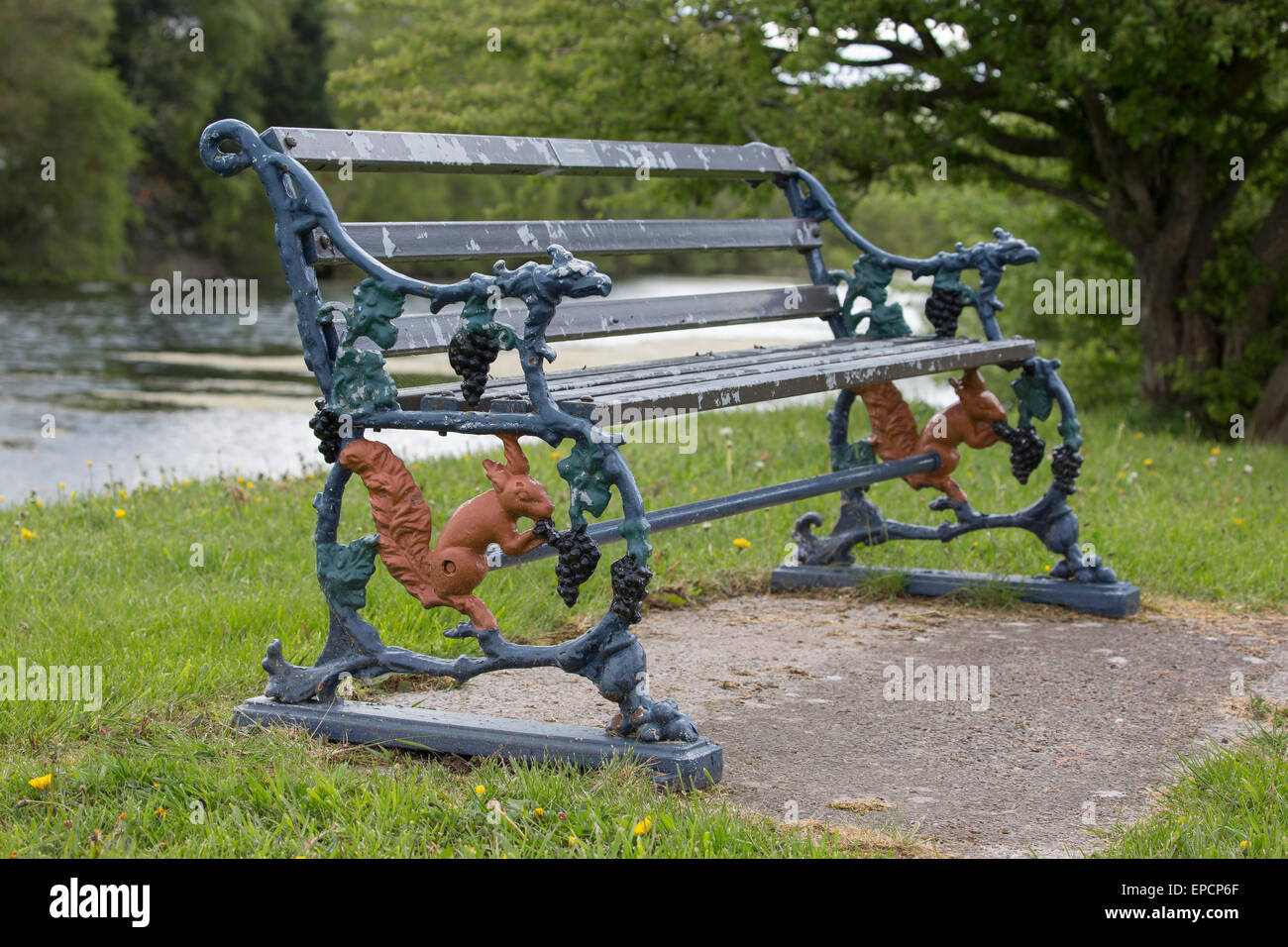 Cast iron bench, with red squirrels and vines, originally from the Furness Railway.  Ulverston, Cumbria Stock Photo
