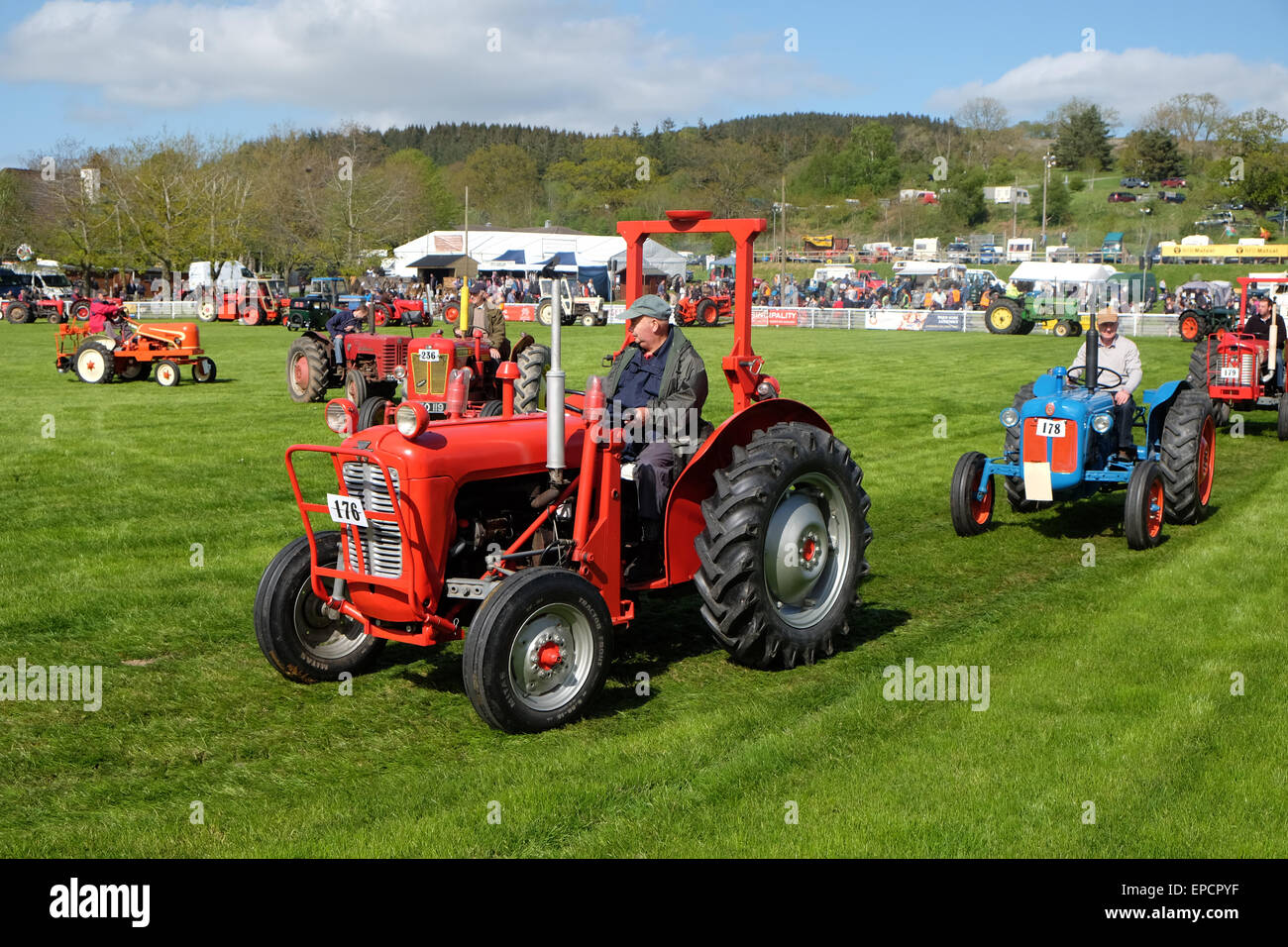 Royal Welsh Spring Festival Builth Wells, Powys, Wales, UK May, 2015. Arena display parade of vintage tractors and vehicles. Over 80 vehicles took part in the procession around the display arena as afternoon sunshine shone on the rural festival showground at Builth Wells. Stock Photo