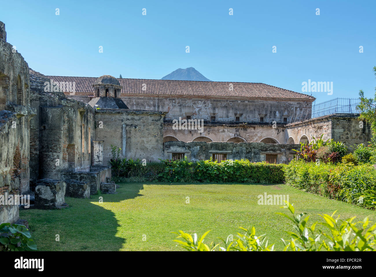 Garden area of Convento de las Capuchinas or Capuchinas Convent in Antigua Guatemala with Volcan Aqua in the background. Stock Photo