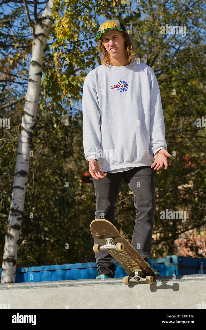 MOSCOW, RUSSIA - OCTOBER 6, 2013: Young russian skater stands at the top of ramp in Moscow, Russia. Stock Photo