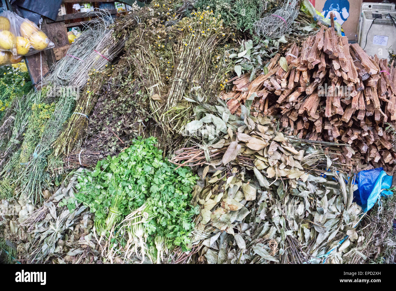 heaped up bundles of dried herbs in a beautiful spectrum of delicate earth tones for sale at main market San Cristobal Stock Photo