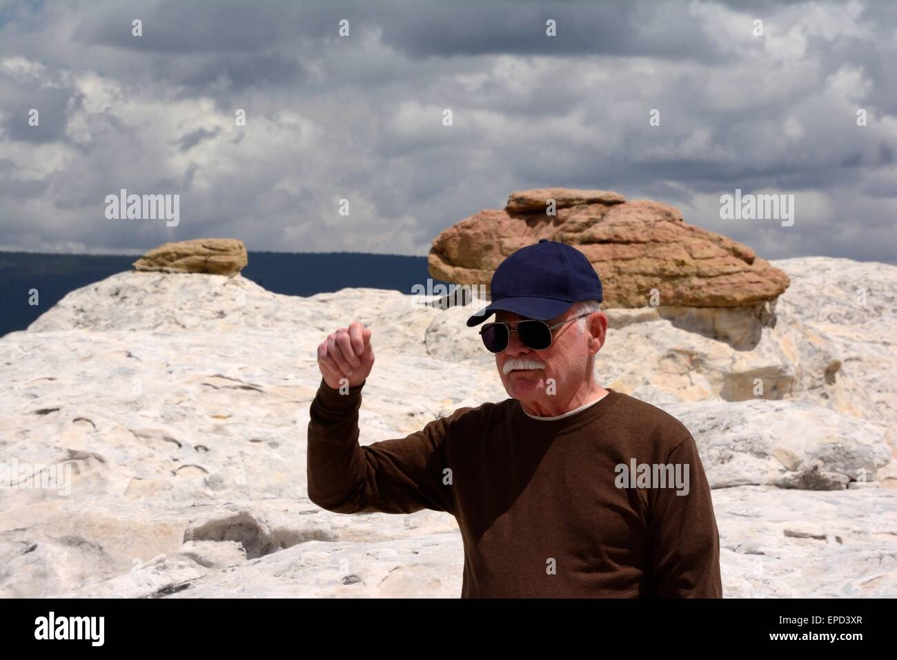 My 80 year old brother about to tip his cap to a female hiker El Morro National Monument New Mexico - USA Stock Photo