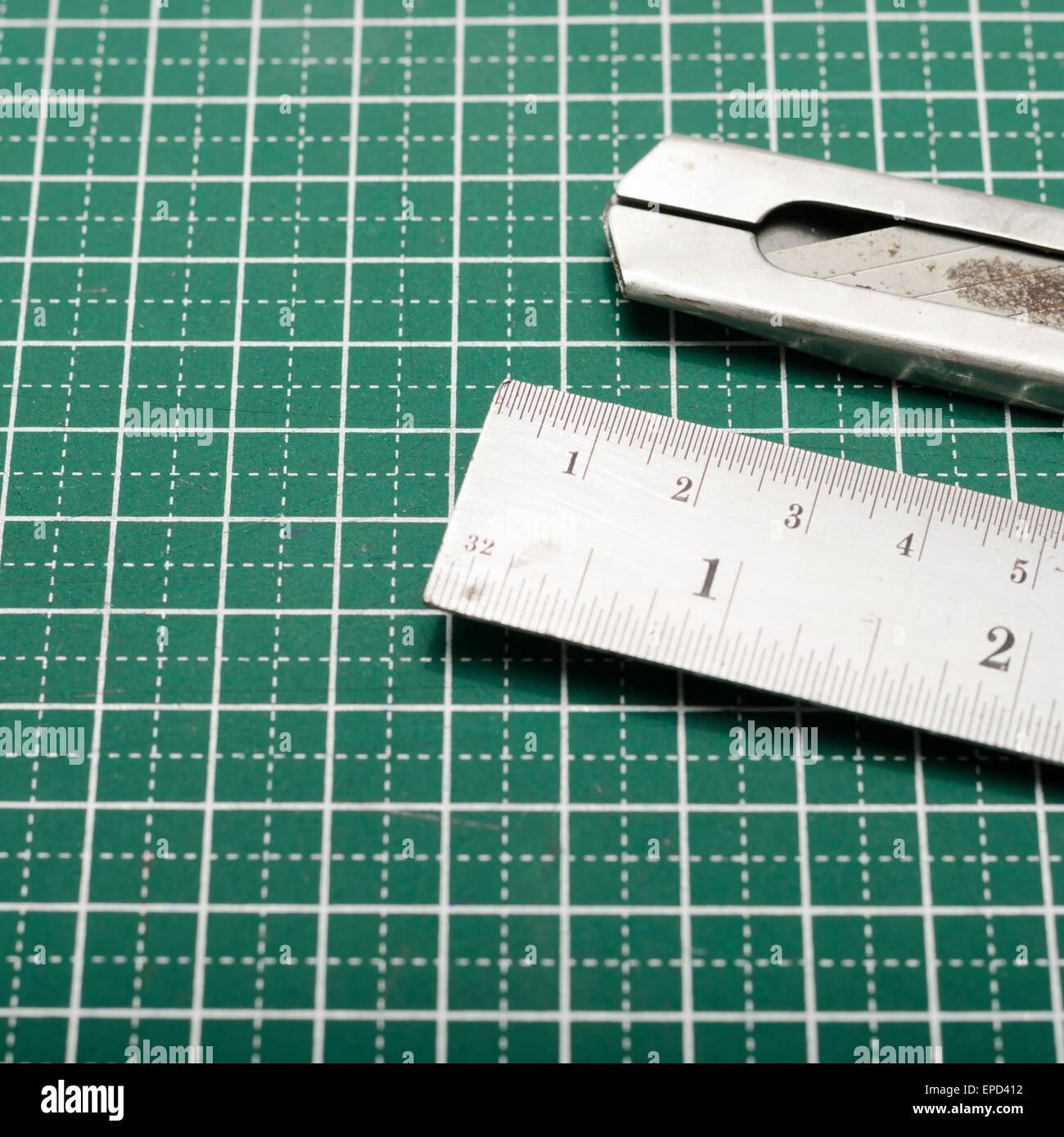 ruler and cutter on green cutting mat Stock Photo Alamy