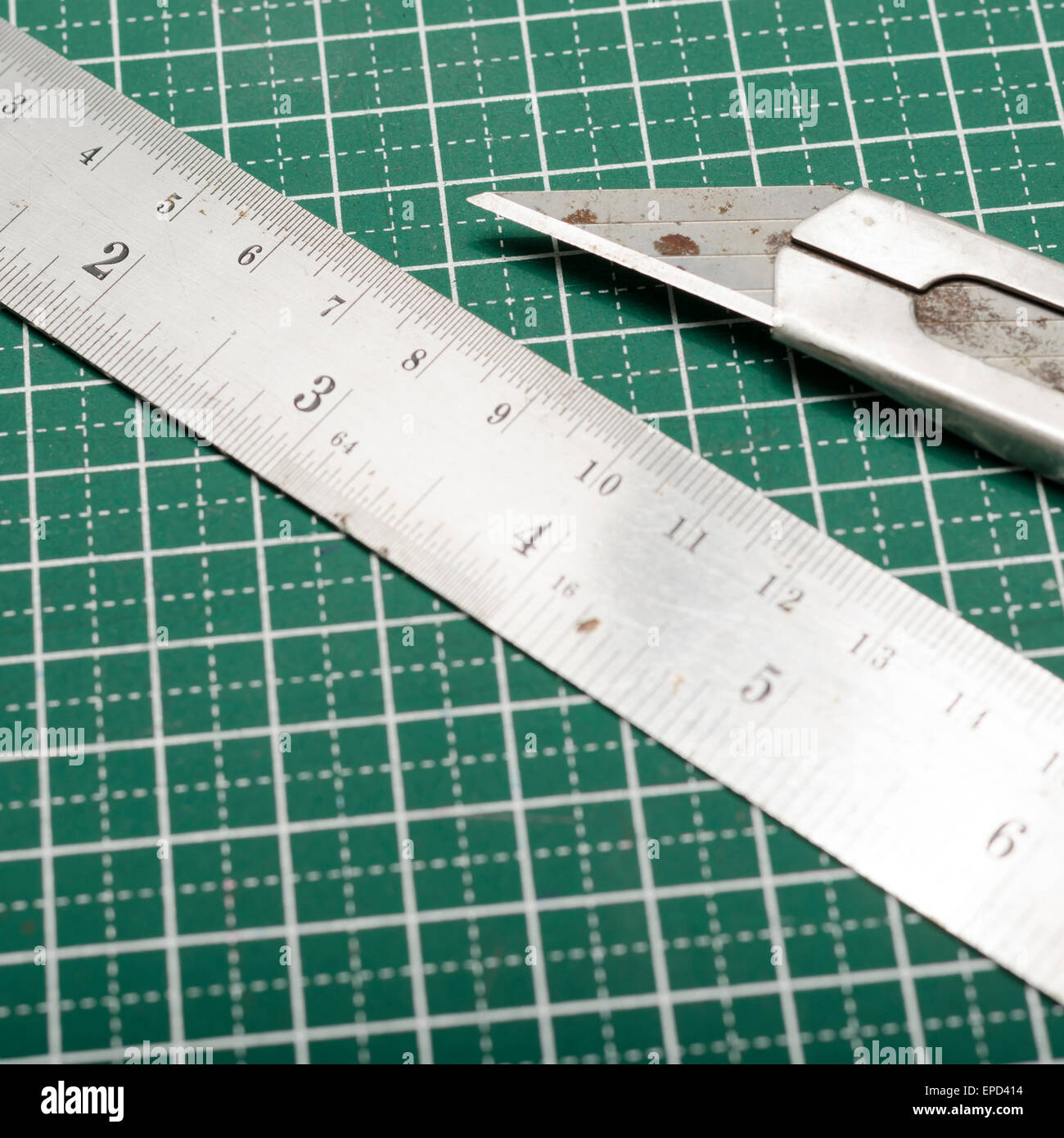 ruler and cutter on green cutting mat Stock Photo Alamy