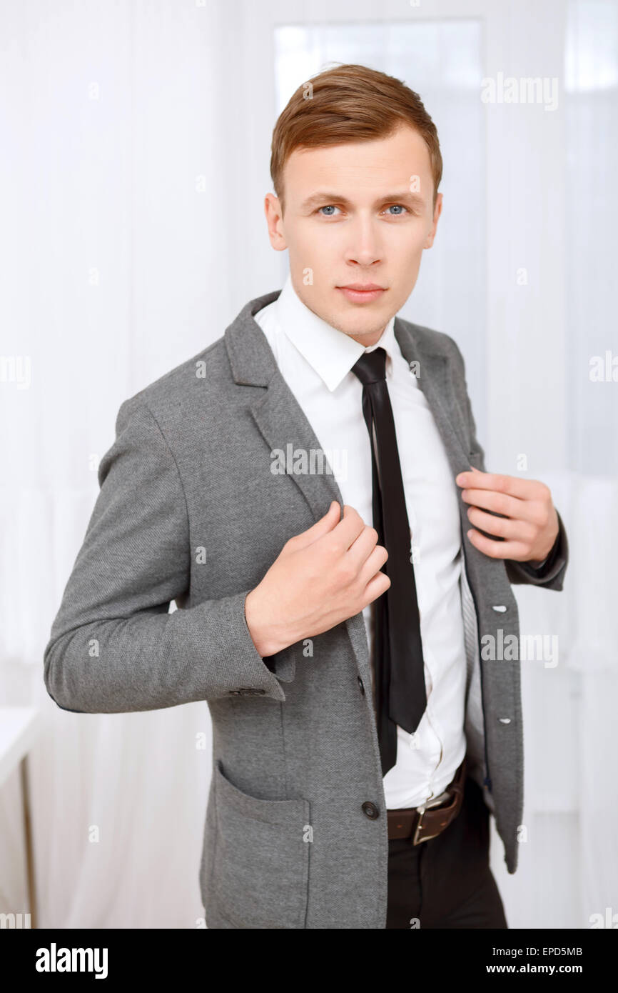 Male Model In A Black Suit Posing Outdoors Stock Photo, Picture and Royalty  Free Image. Image 68190859.