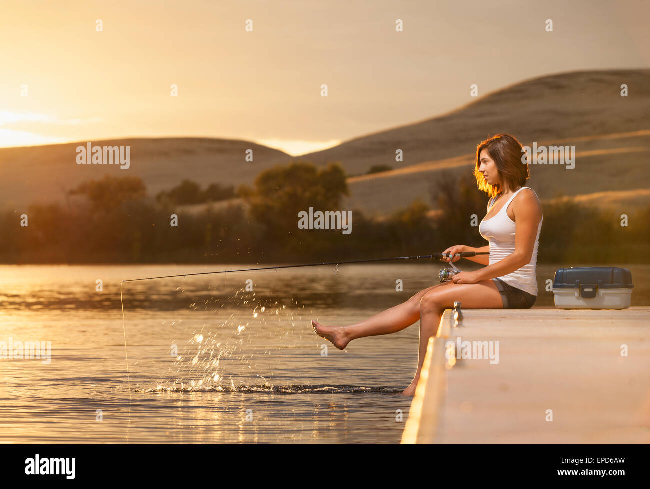 Young woman fishing pole on hi-res stock photography and images - Alamy