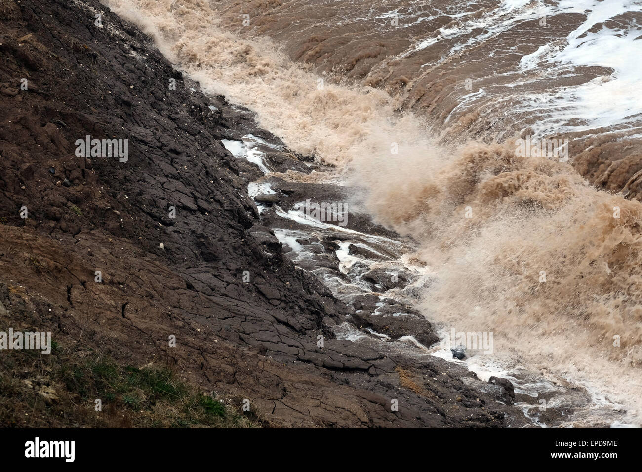 Rough water in the north sea causing heavy clay cliff erosion on the east coast of Yorkshire, UK