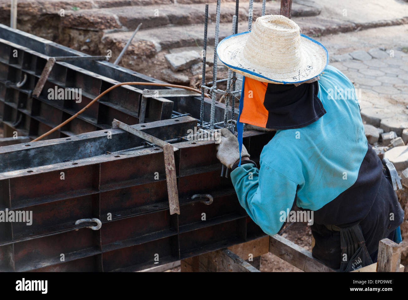 Chiang Mai, Thailand - April 26, 2015: The worker is constructing underground floor of the building in Rampoeng temple. Stock Photo