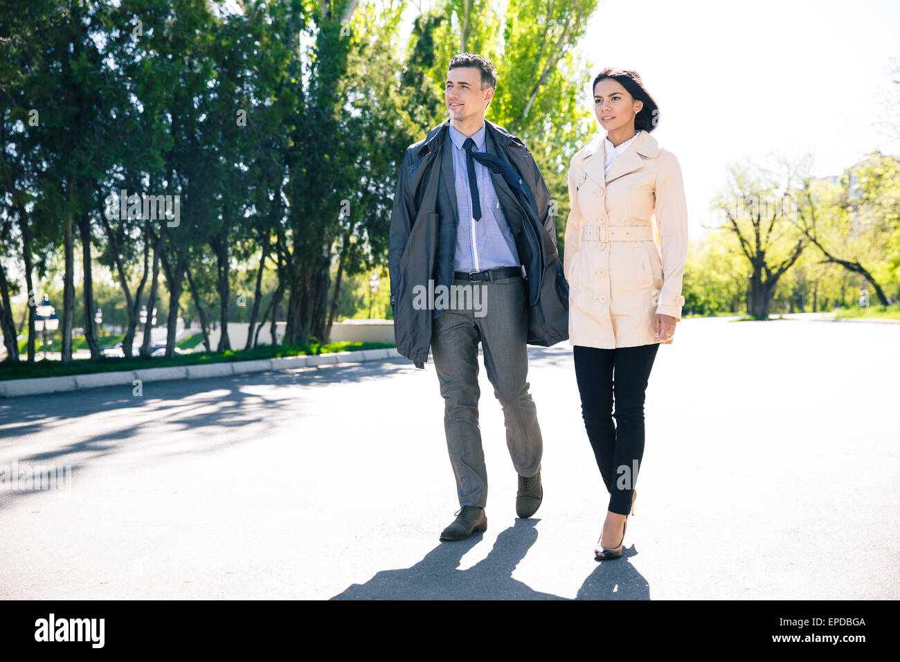 Portrait of a beautiful couple walking in park Stock Photo - Alamy