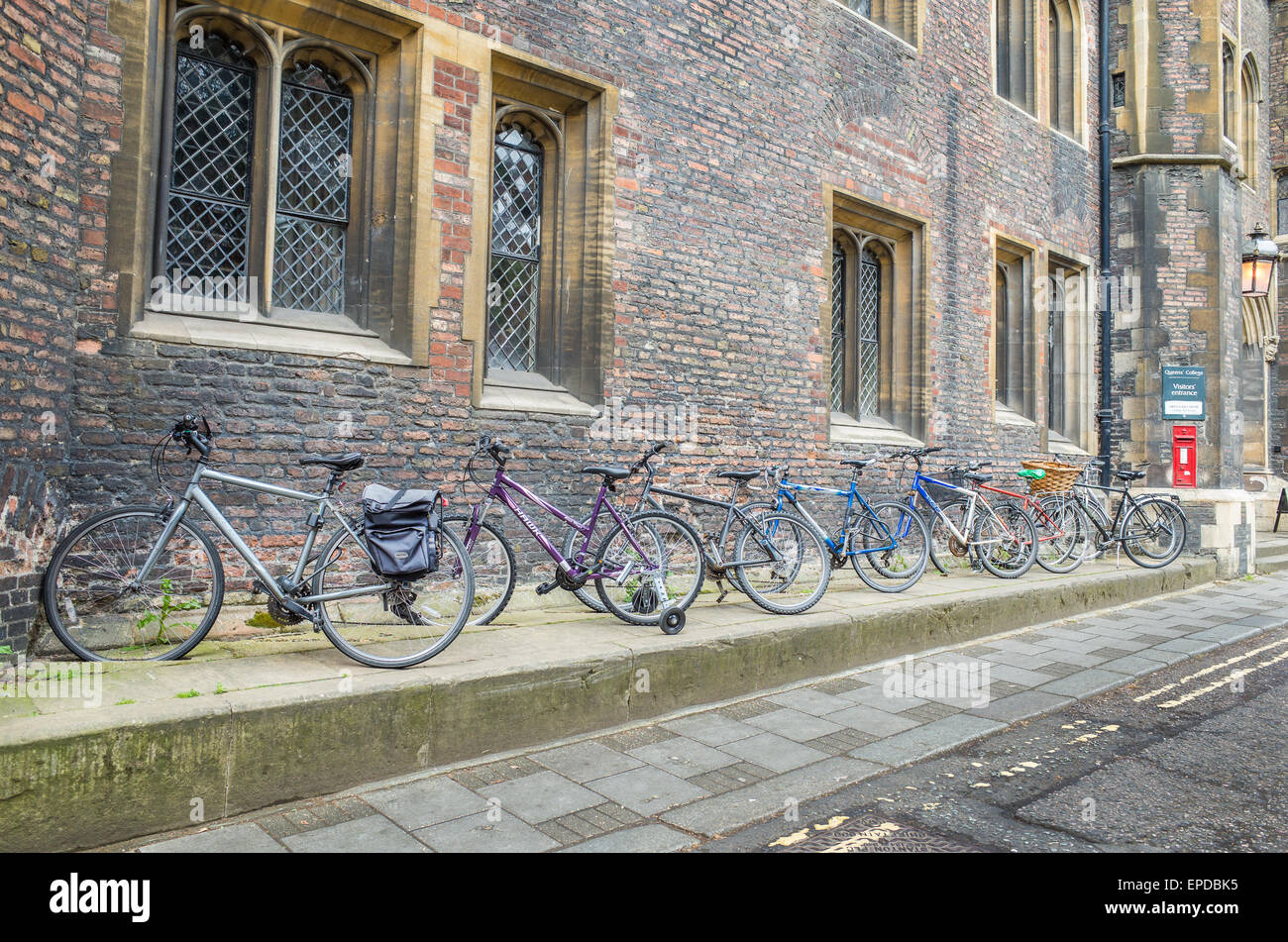 Bicycles parked outside Queen's college, Cambridge university, England. Stock Photo