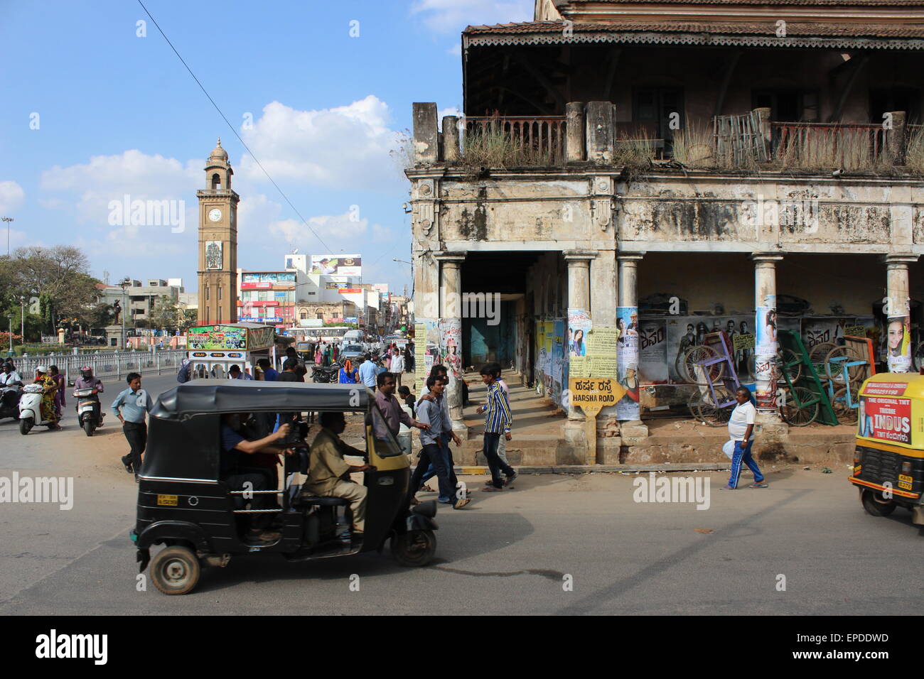 The streets and markets of central Mysore: a view of the clocktower and a pre-Independence corner building Stock Photo