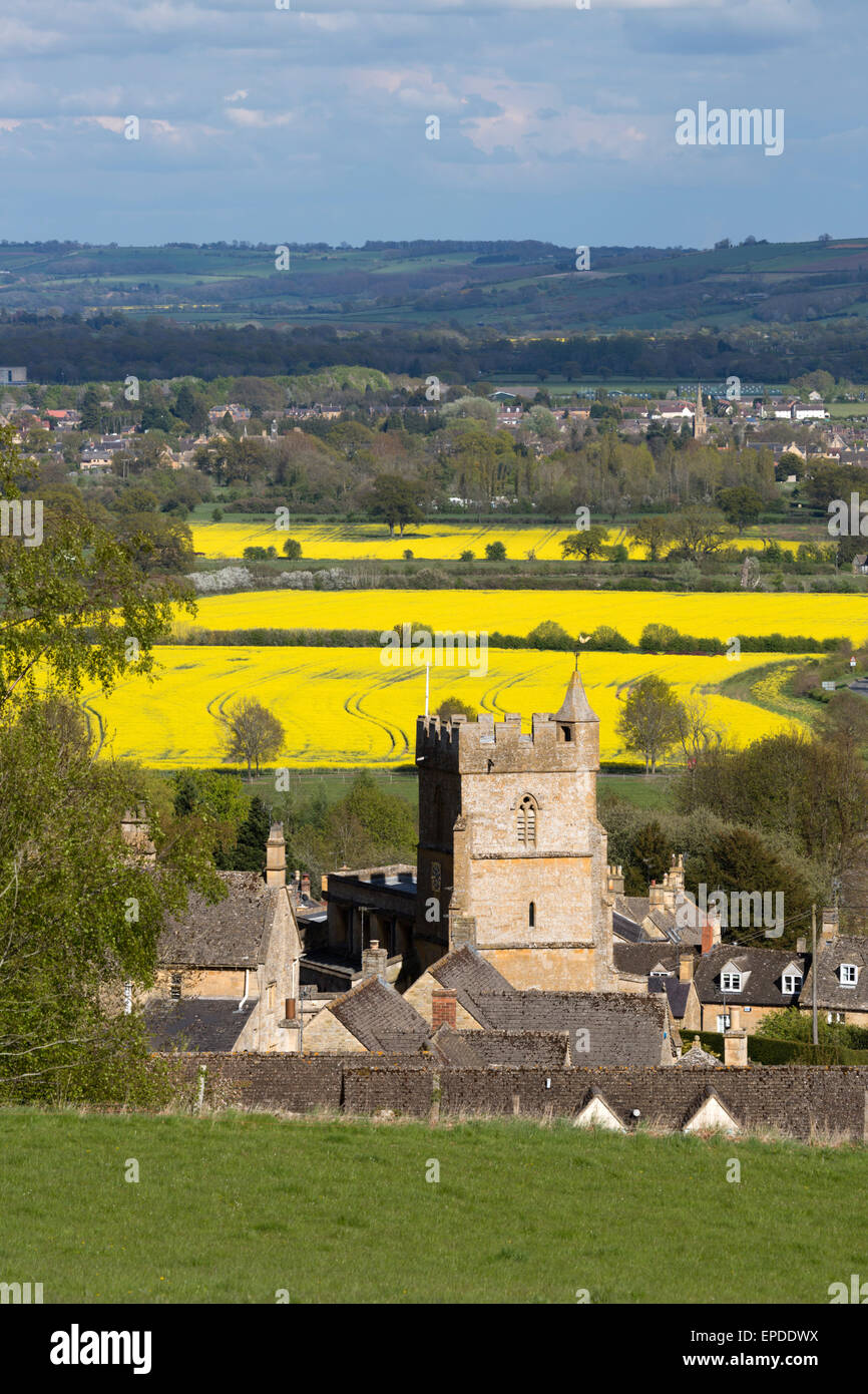 Saint Lawrence church and cotswold landscape with oilseed rape fields, Bourton-on-the-Hill, Cotswolds, Gloucestershire, England, Stock Photo