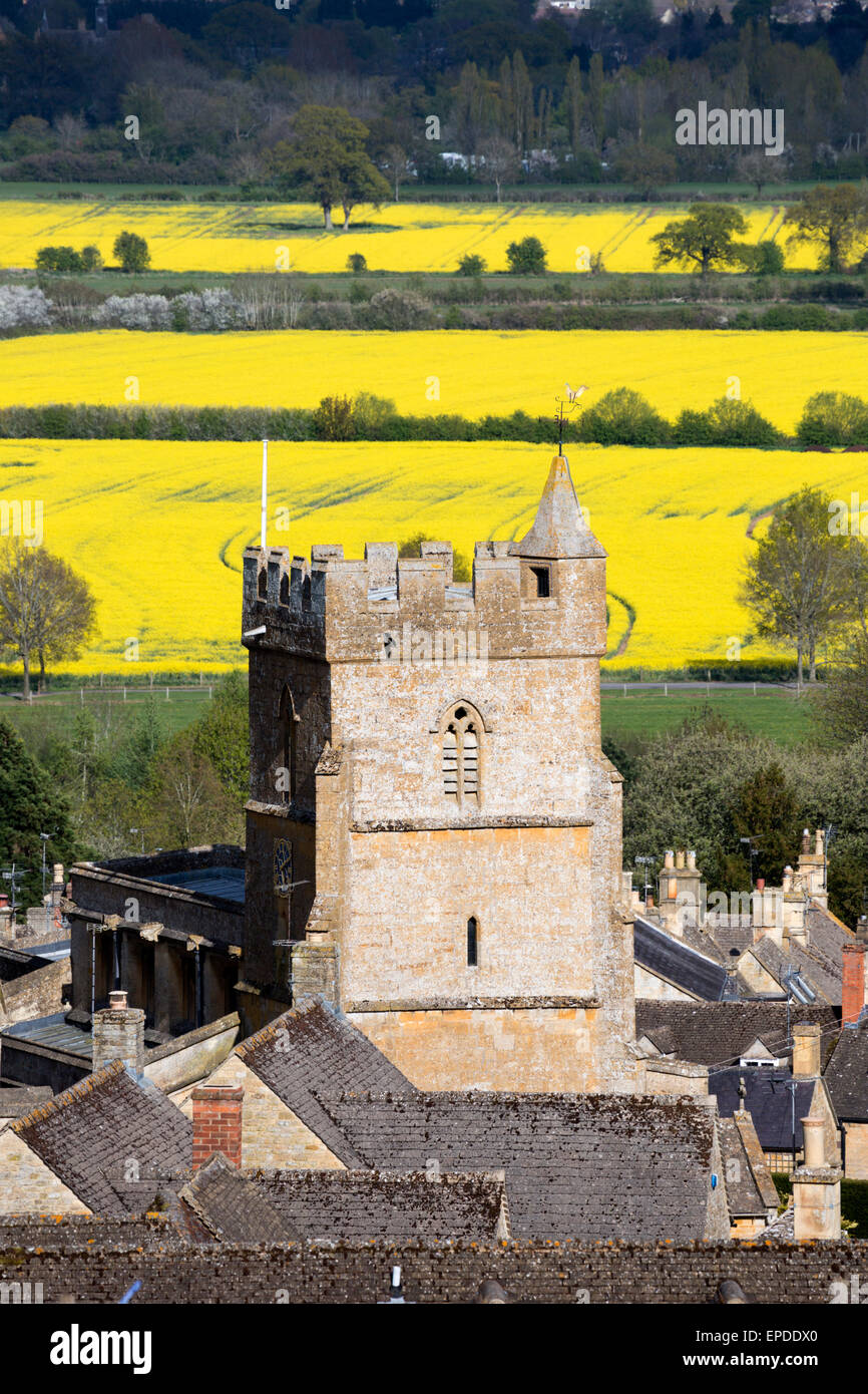 Saint Lawrence church and cotswold landscape with oilseed rape fields, Bourton-on-the-Hill, Gloucestershire, England, UK Stock Photo