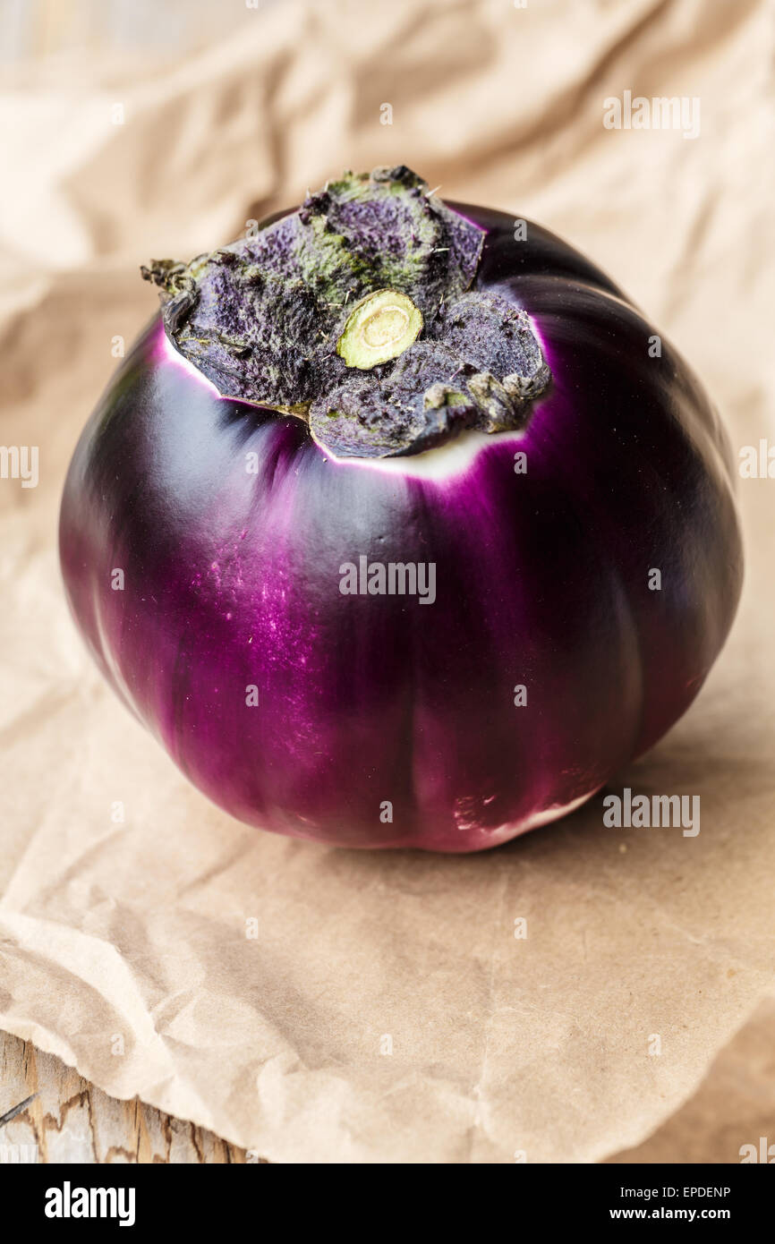 Round eggplant on paper leaf Stock Photo