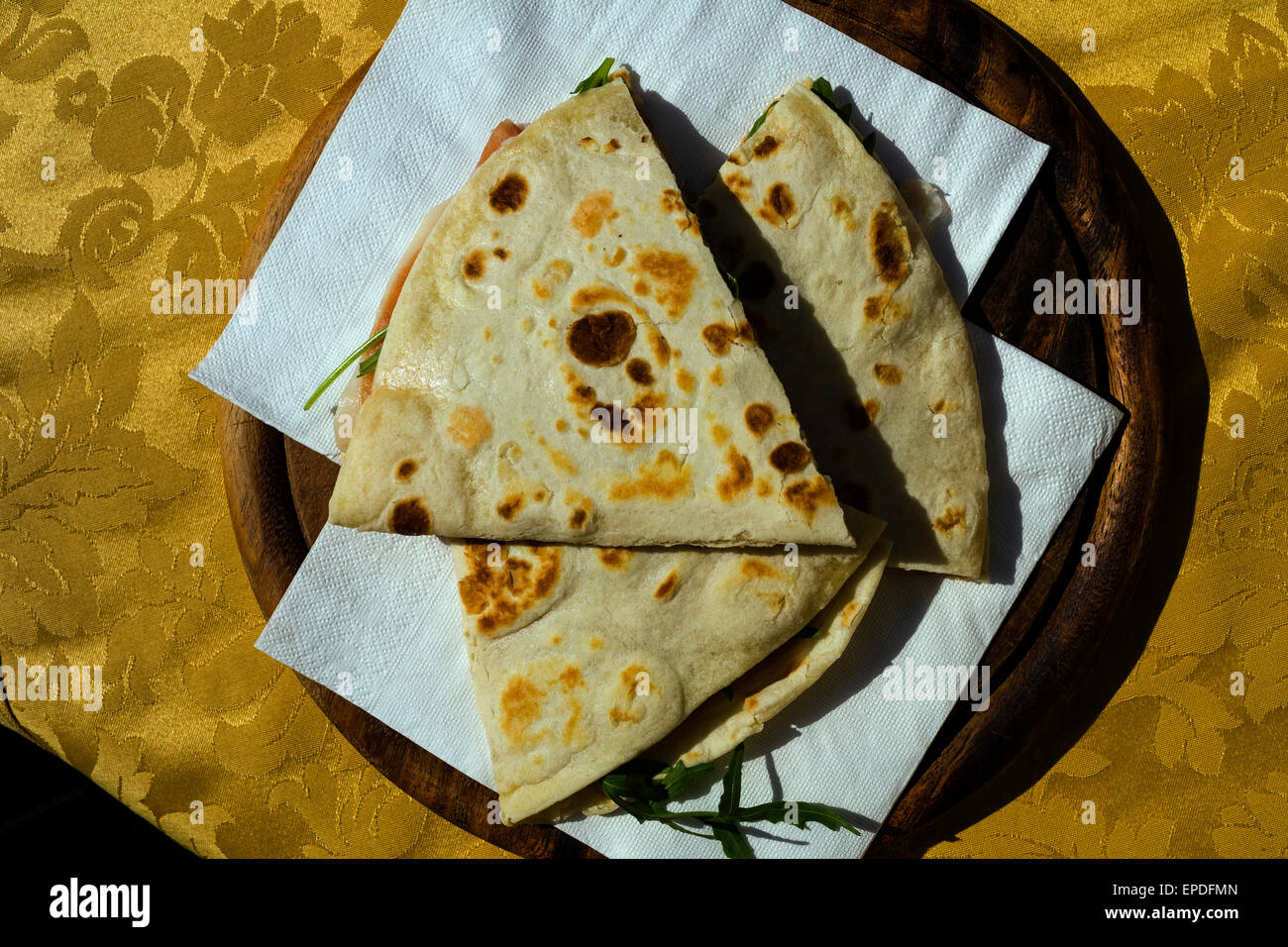 Flatbread sandwich on a wooden platter in a traditional Bulgarian restaurant Stock Photo