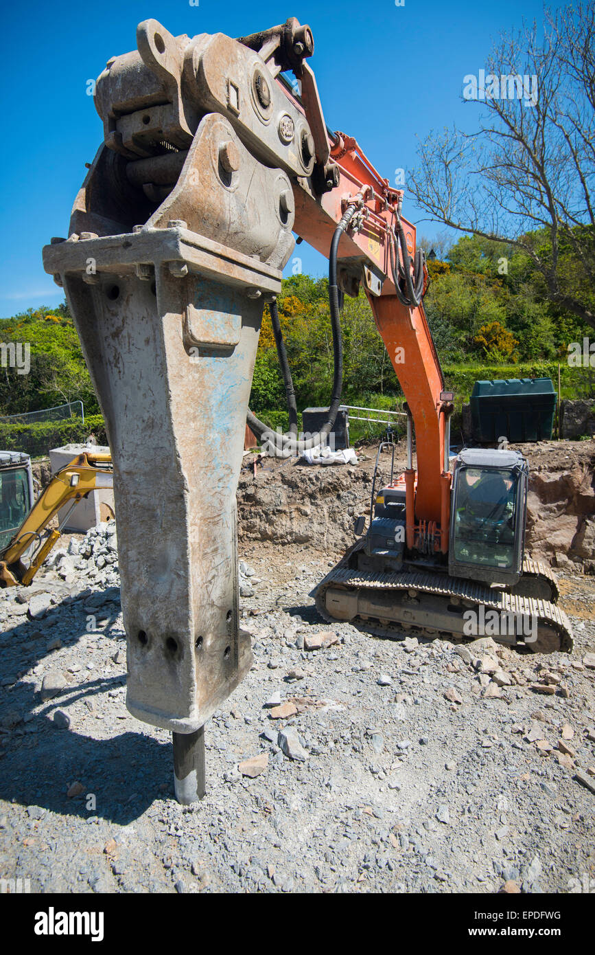 Excavator with hydraulic hammer, in a quarry. Stock Photo