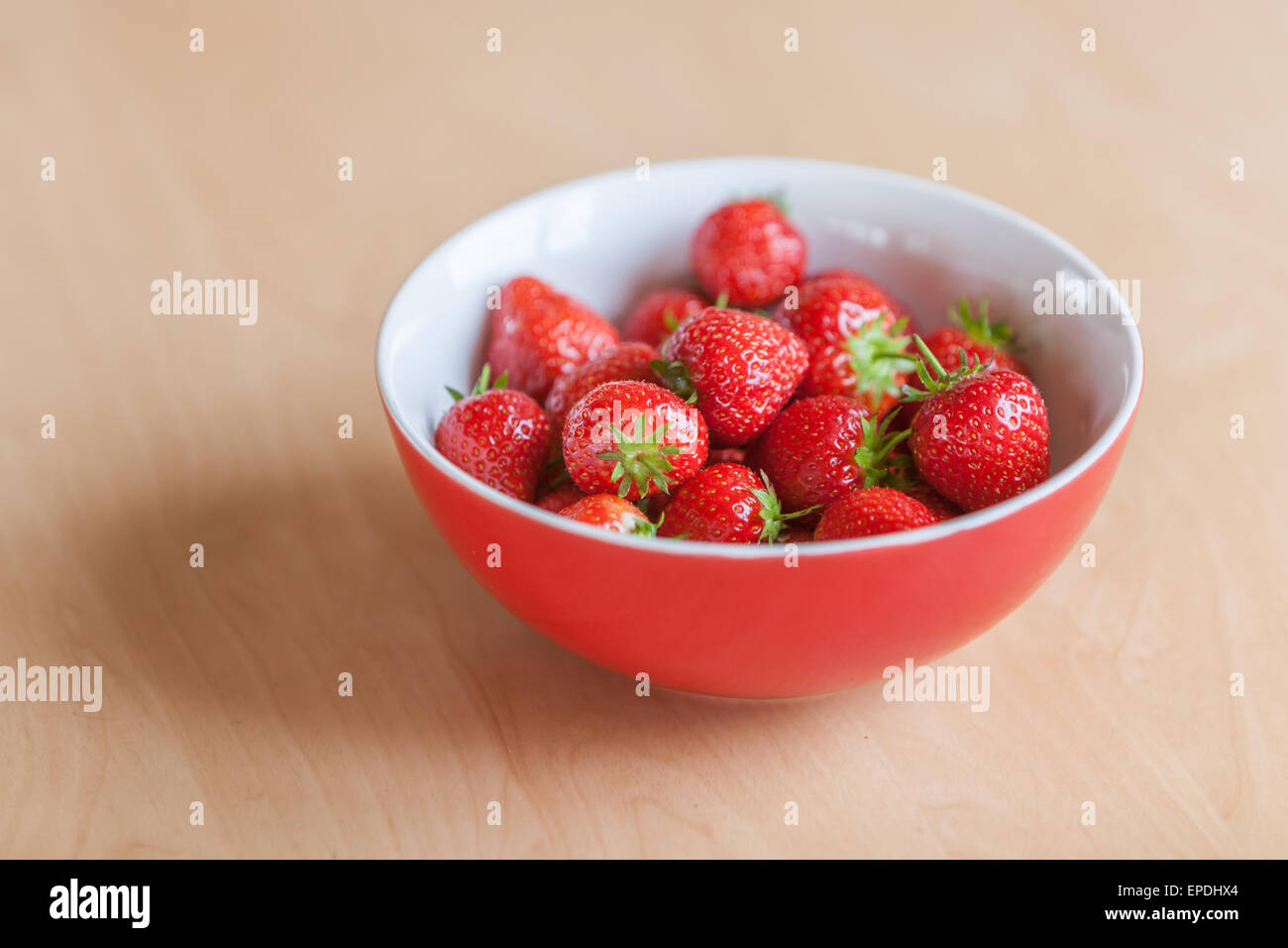 A bowl full of luscious red British Strawberries in the sunlight, healthy summer food and lifestyle Stock Photo