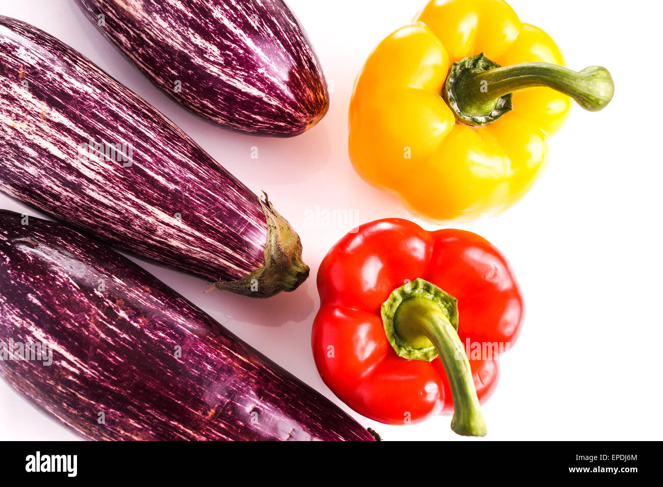 Raw ripe Striped healthy eggeplants and bell peppers, isolated on white Stock Photo
