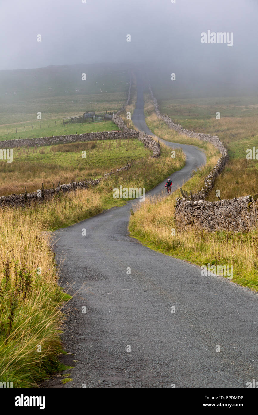 UK, England.  Rider Cycling in the Yorkshire Dales in Autumn. Stock Photo