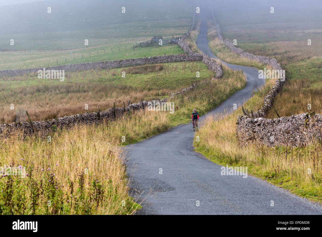 UK, England.  Rider Cycling in the Yorkshire Dales in Autumn. Stock Photo