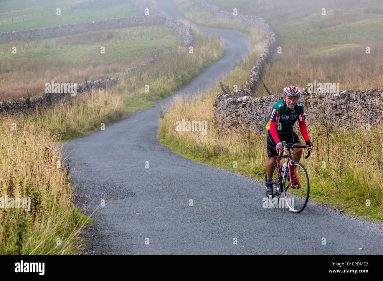 UK, England.  Rider Cycling in the Yorkshire Dales in Autumn. Stock Photo