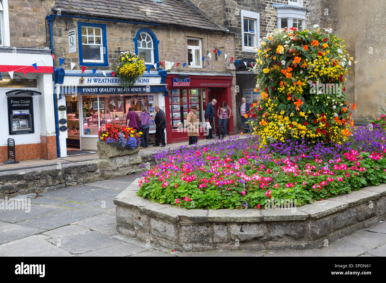 UK, England, Pateley Bridge, Yorkshire.  Village Square, Flowers, and Shops. Stock Photo