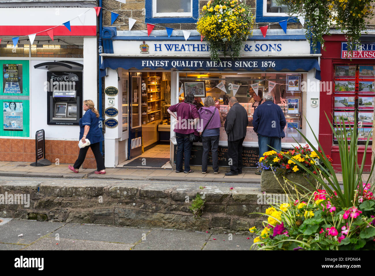 UK, England, Pateley Bridge, Yorkshire.  Butcher Shop and ATM Machine seen from the Village Square. Stock Photo