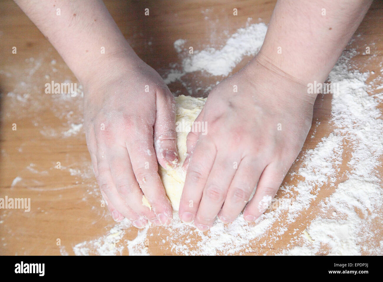 woman kneads the dough on the table Stock Photo - Alamy