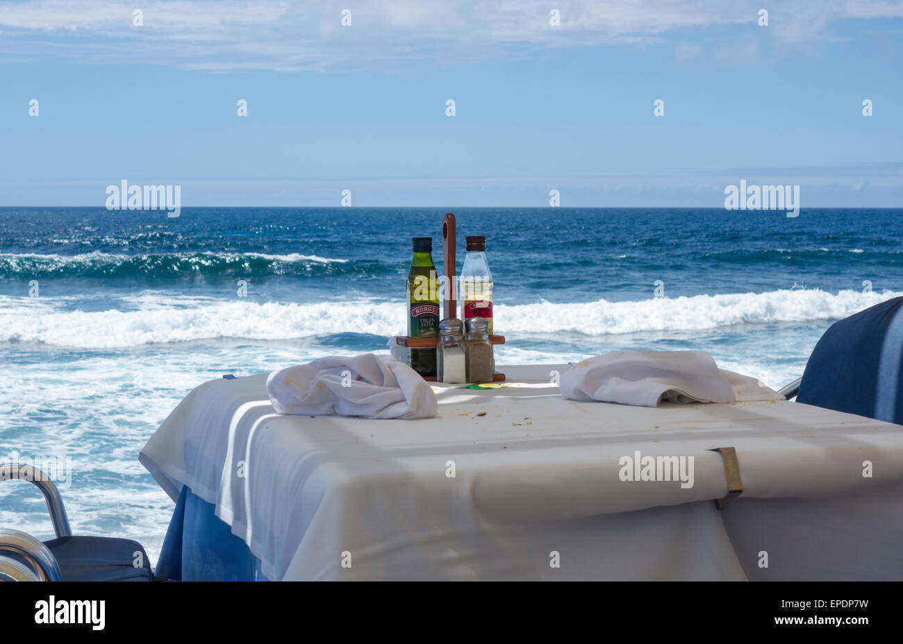 Empty restaurant table overlooking Ocean Stock Photo