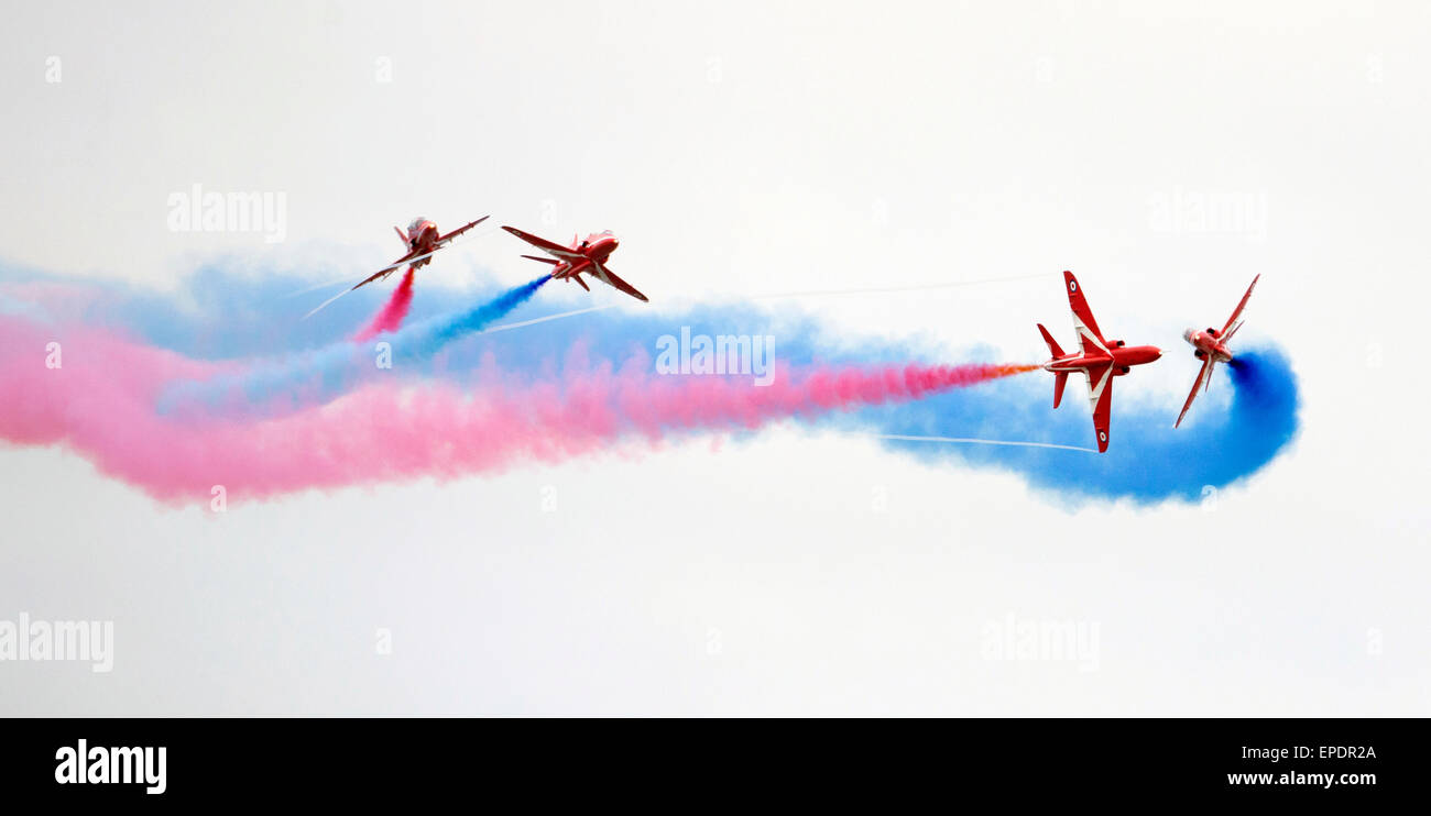 RED ARROWS FLYING THROUGH THIER SWIRLING COLOURED SMOKE TRIALS. Stock Photo