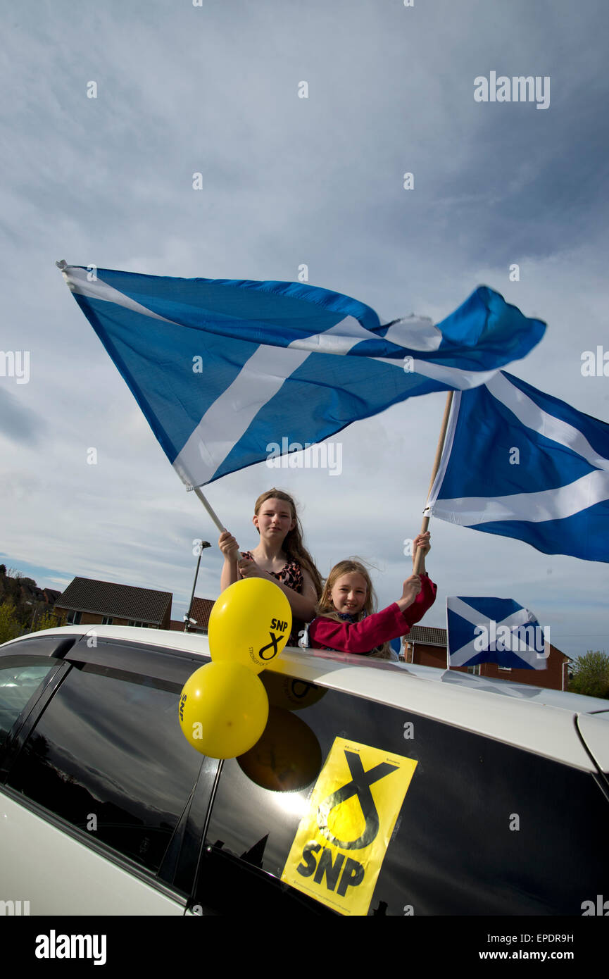 Eve of election calvacade around the town by the SNP (Scottish National Party). Two young girls wave Saltaires. Stock Photo