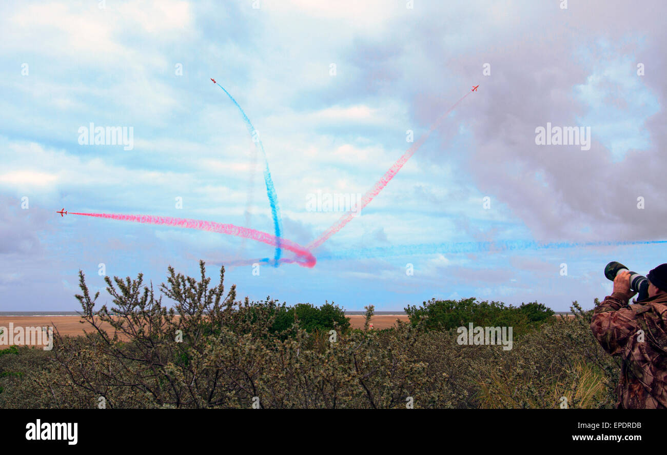RED ARROWS FLYING THROUGH THIER SWIRLING COLOURED SMOKE TRIALS. Stock Photo