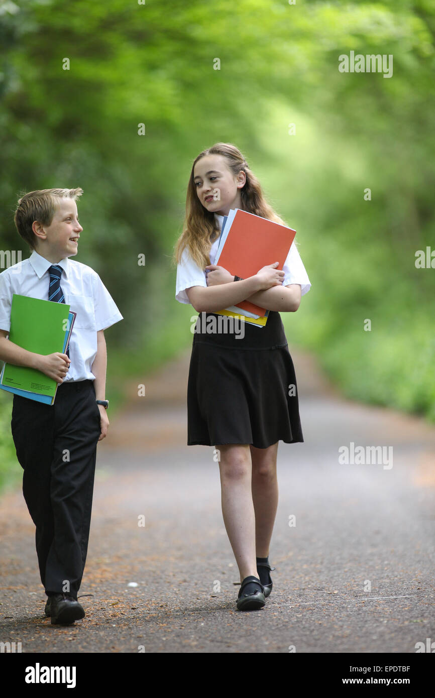 School pupils in uniform walking to school UK Stock Photo