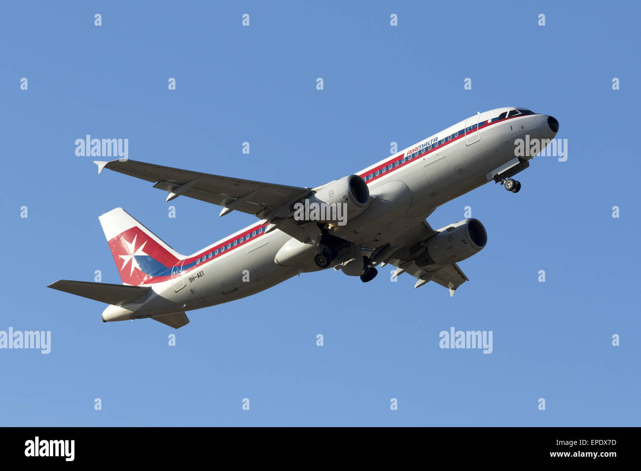 Air Malta Airbus A320-214 (9H-AEI) in retro livery takes off from runway 13. Stock Photo