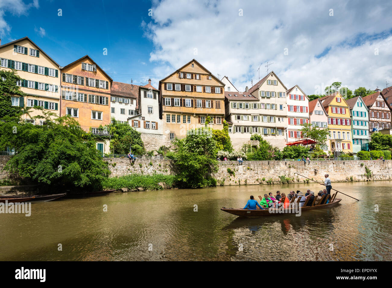 Tubingen, Germany - May 17,2015: A traditional punt is passing the beautiful waterfront of Tubingen (Tuebingen) in the south of Stock Photo