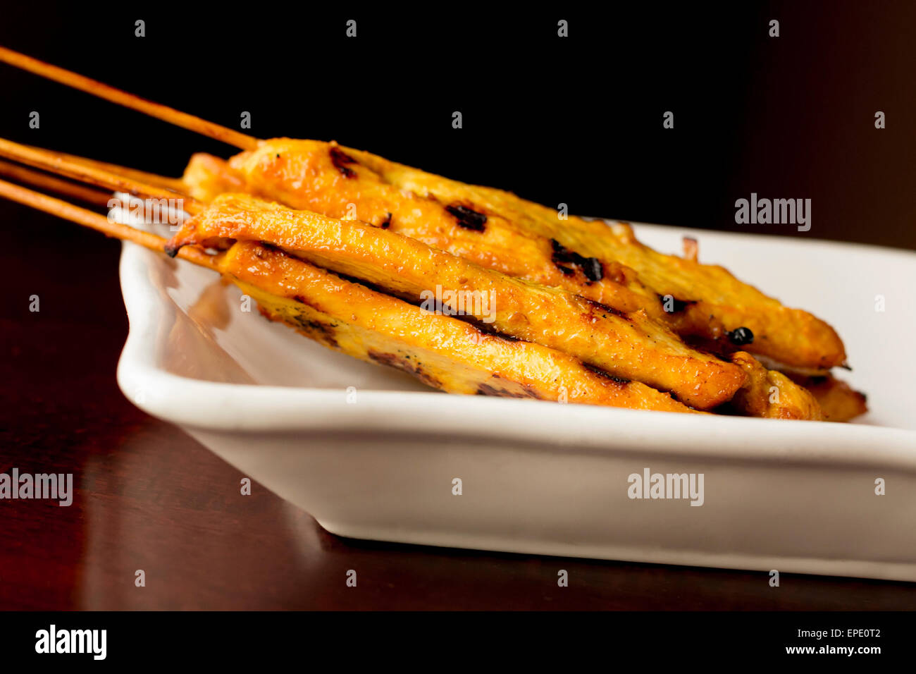 Thai chicken satay skewers with spicy peanut sauce for dipping Stock