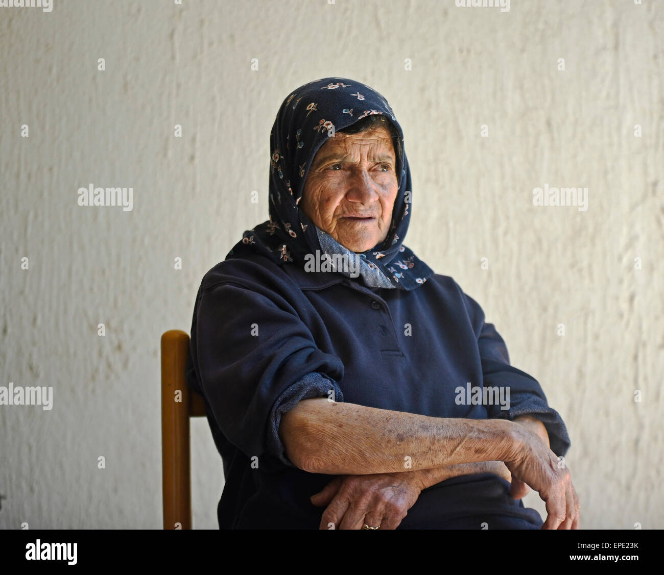 Greek Cypriot woman taking shelter from hot temperatures Stock Photo
