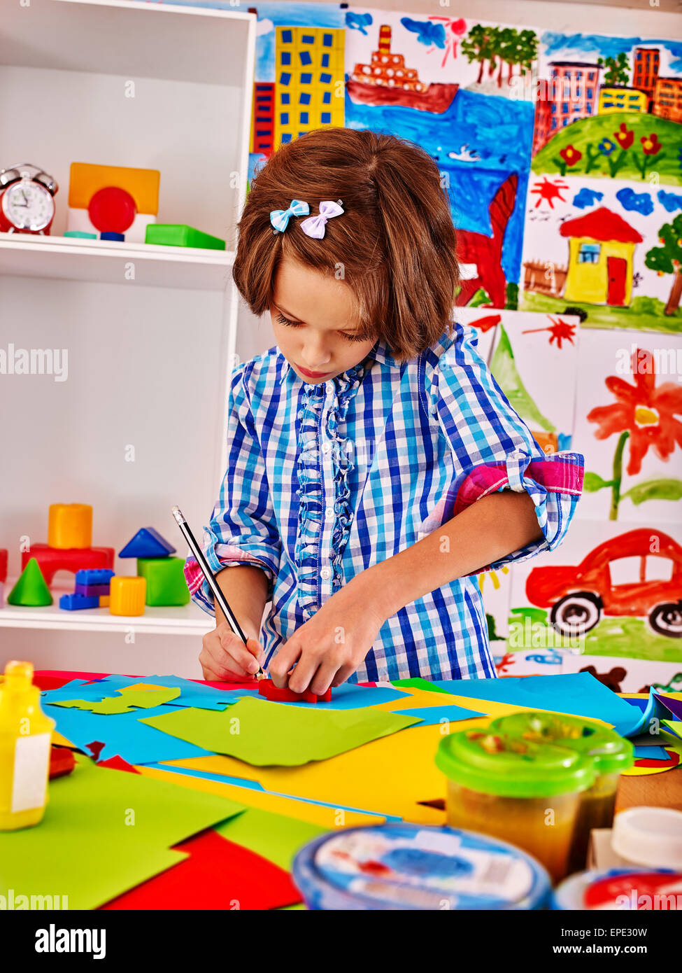 Child painting at easel Stock Photo Alamy