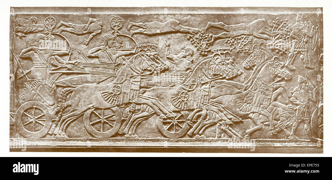 This marble slab shows the horse in warfare. The royal figure is Assyrian king Ashurnasirpal II (died c. 860 B.C.) and  his army is advancing against a besieged town. A battering ram is being drawn on a six-wheeled carriage. The slab is from  Ashurnasirpal II's N.W. palace in Nimrud (ancient Kalhu) in present-day Iraq. It is presently in the British Museum. Stock Photo