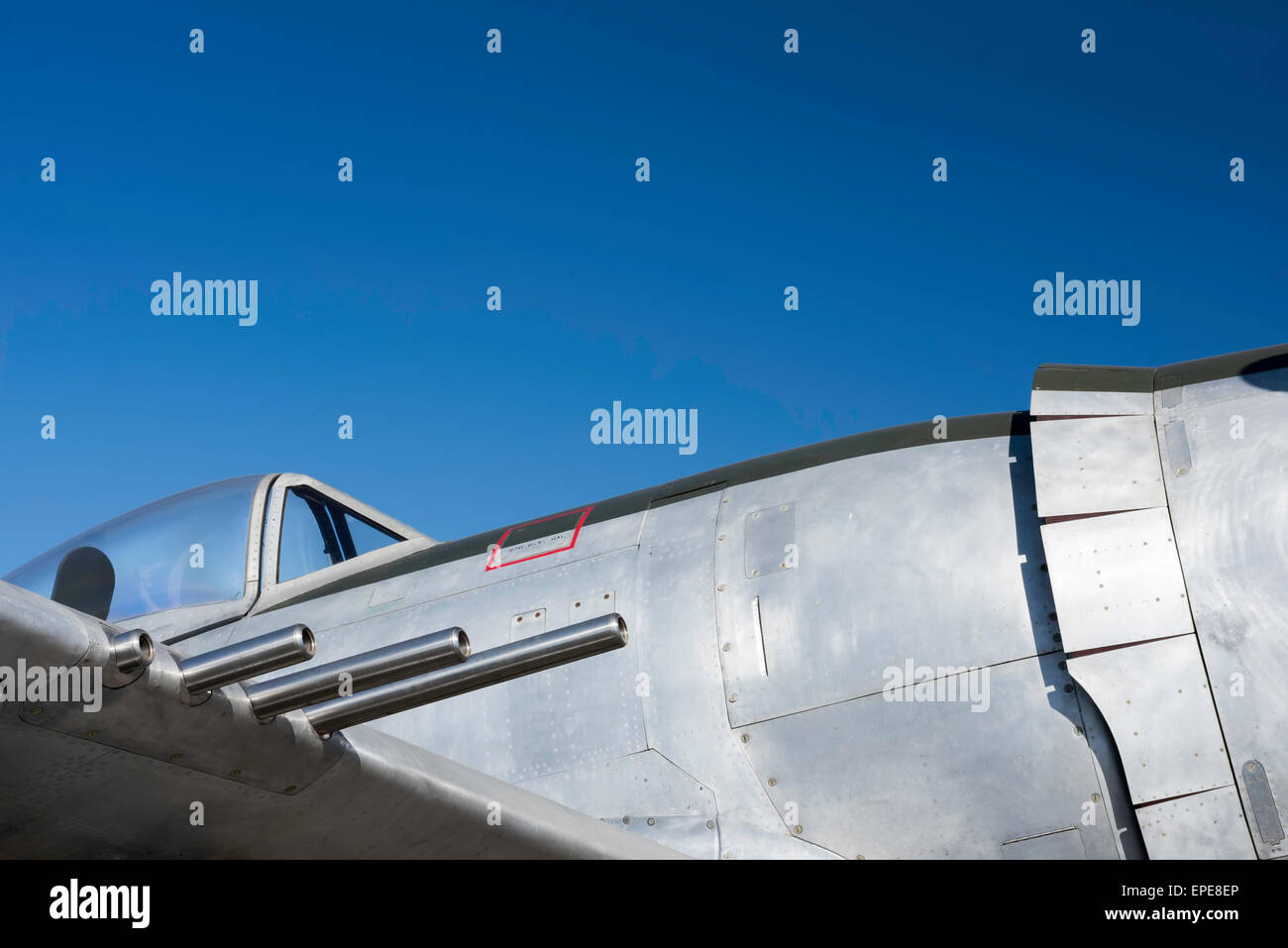 Vintage fighter guns cockpit and fuselage with a blue sky behind it Stock Photo