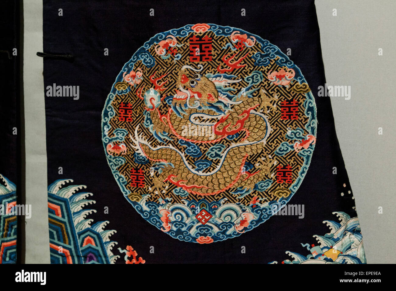 Vintage Chinese silk roundel depicting a leaping dragon (Chinese embroidery) Stock Photo
