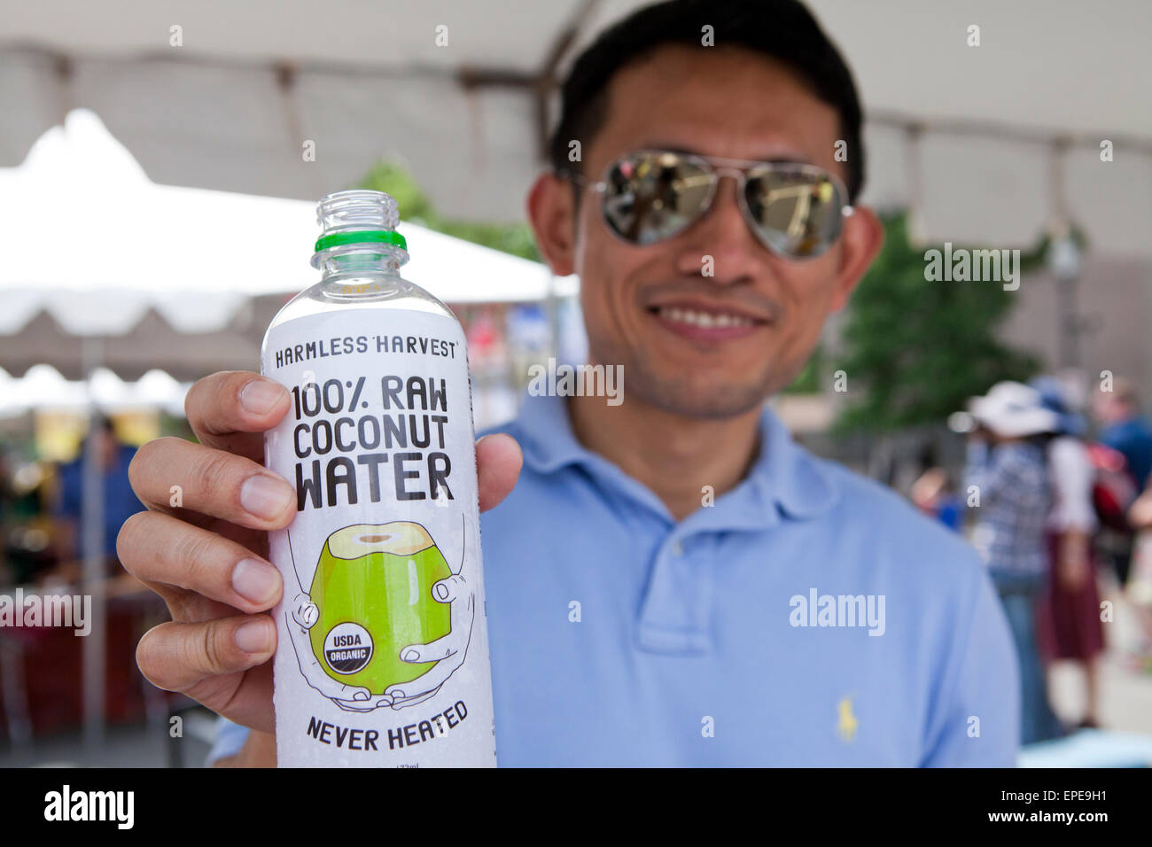 Man holding bottled organic coconut water USA Stock Photo Alamy
